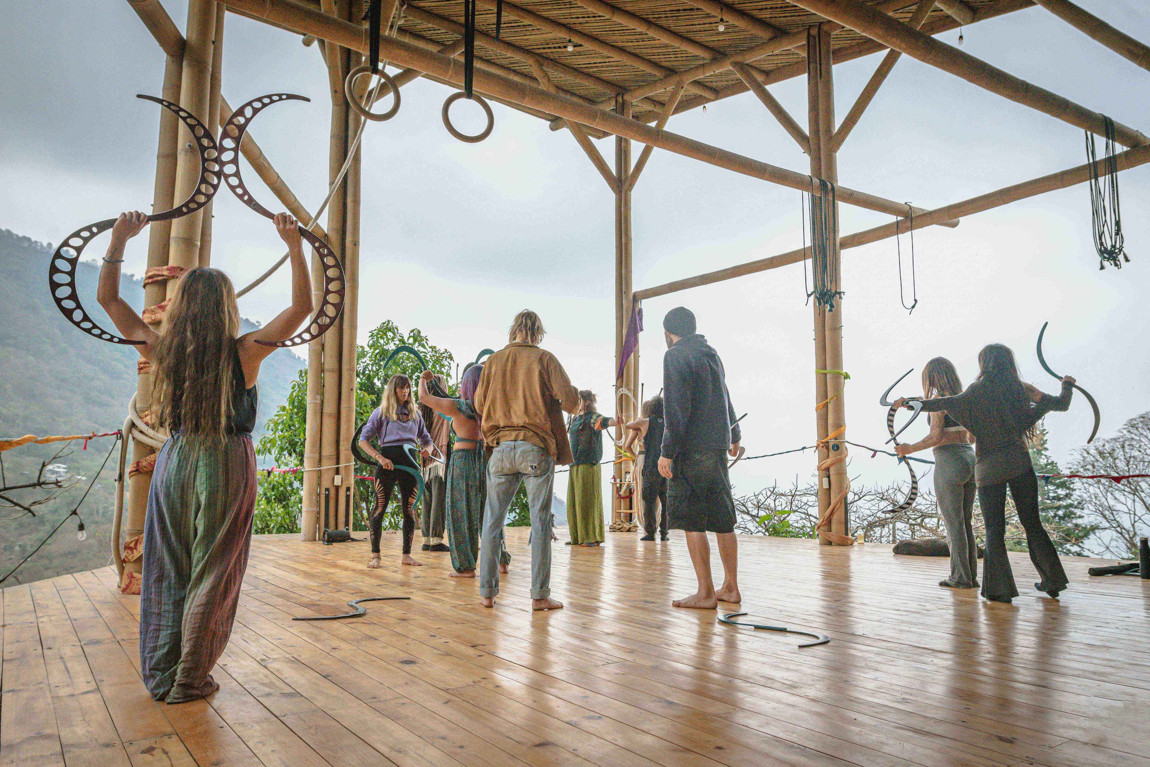 Retreat group on a wooden deck facing the mountains
