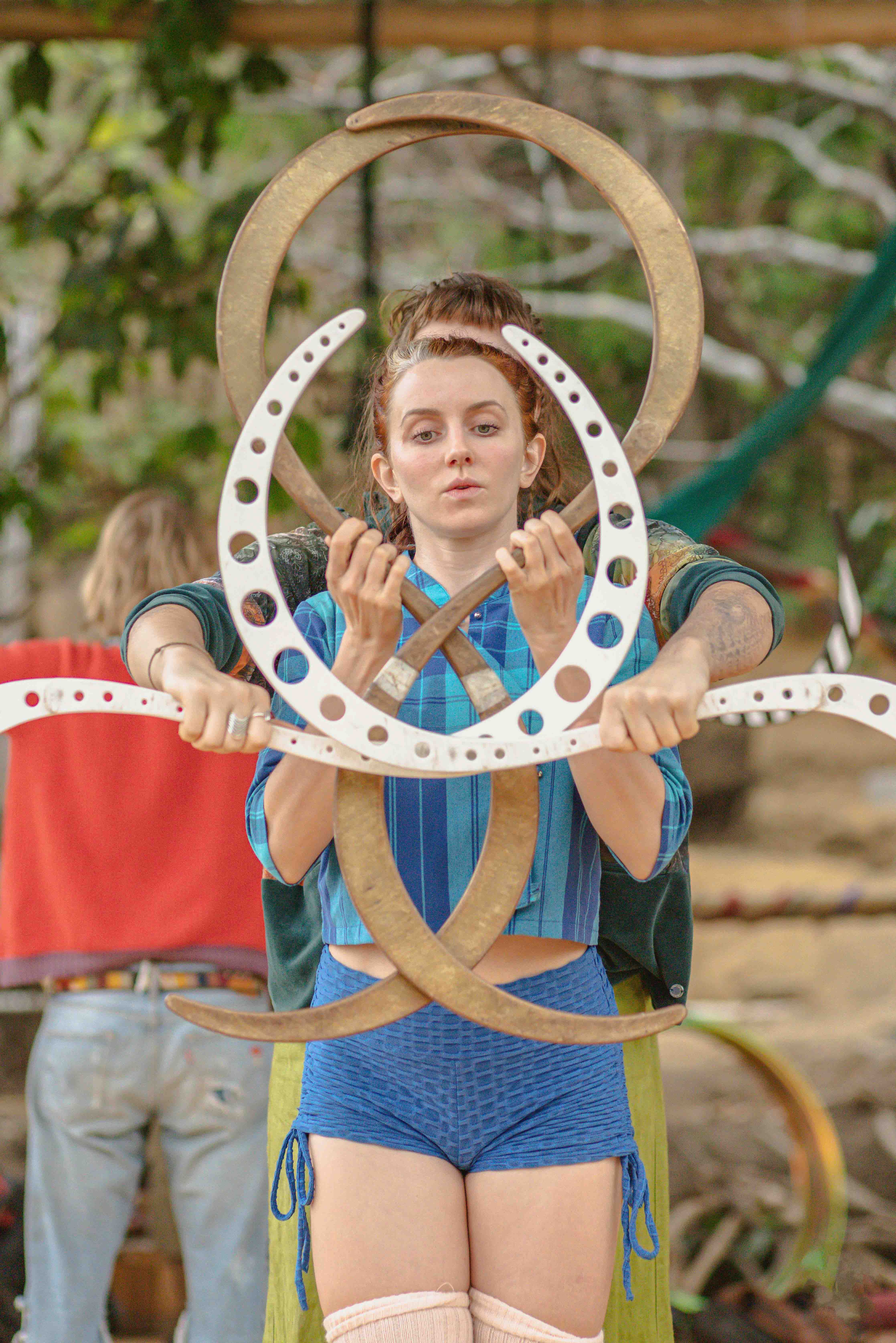 Smiling young performer with openwork hoops